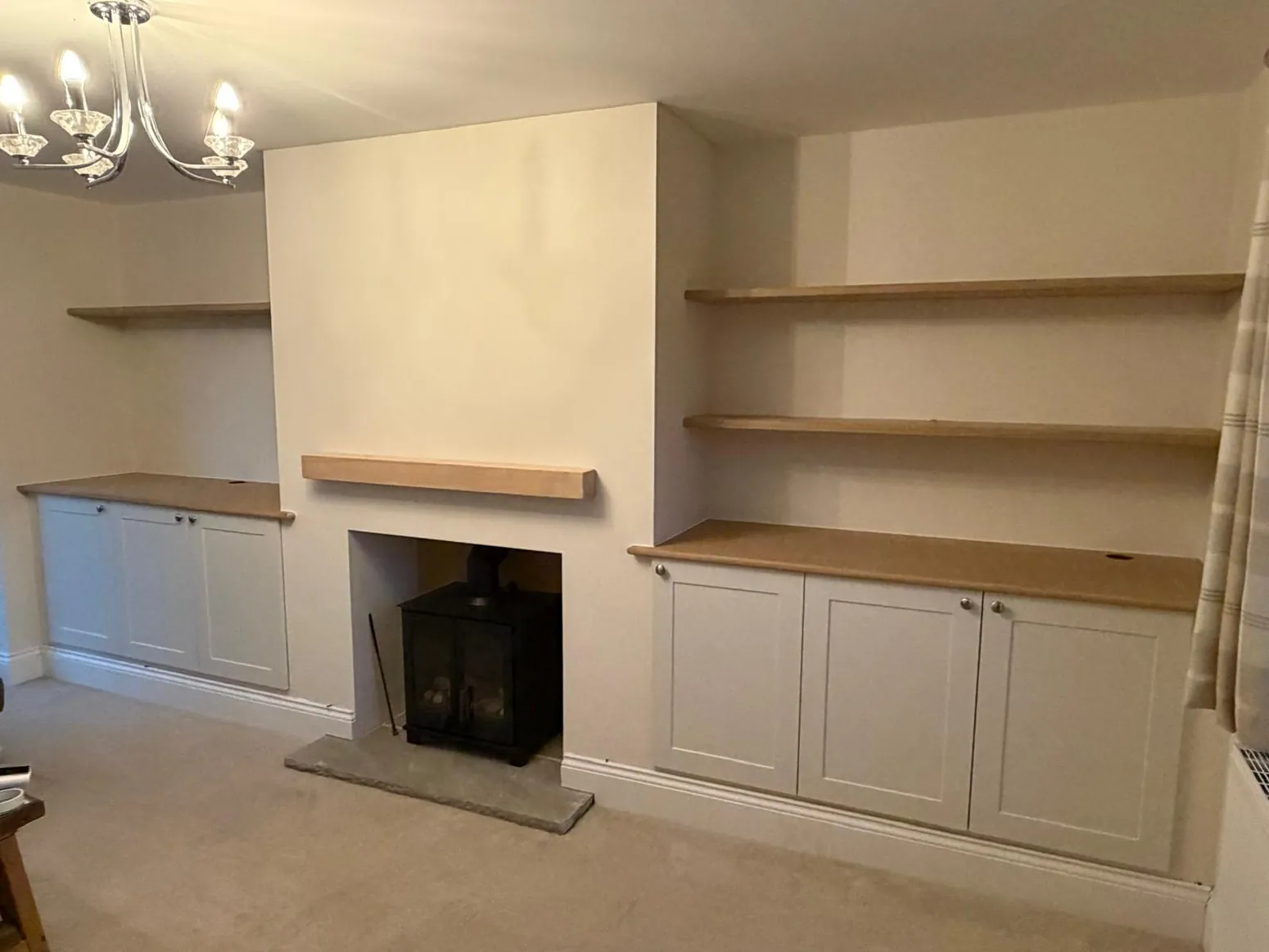 Bespoke lounge storage with cupboards and shelving