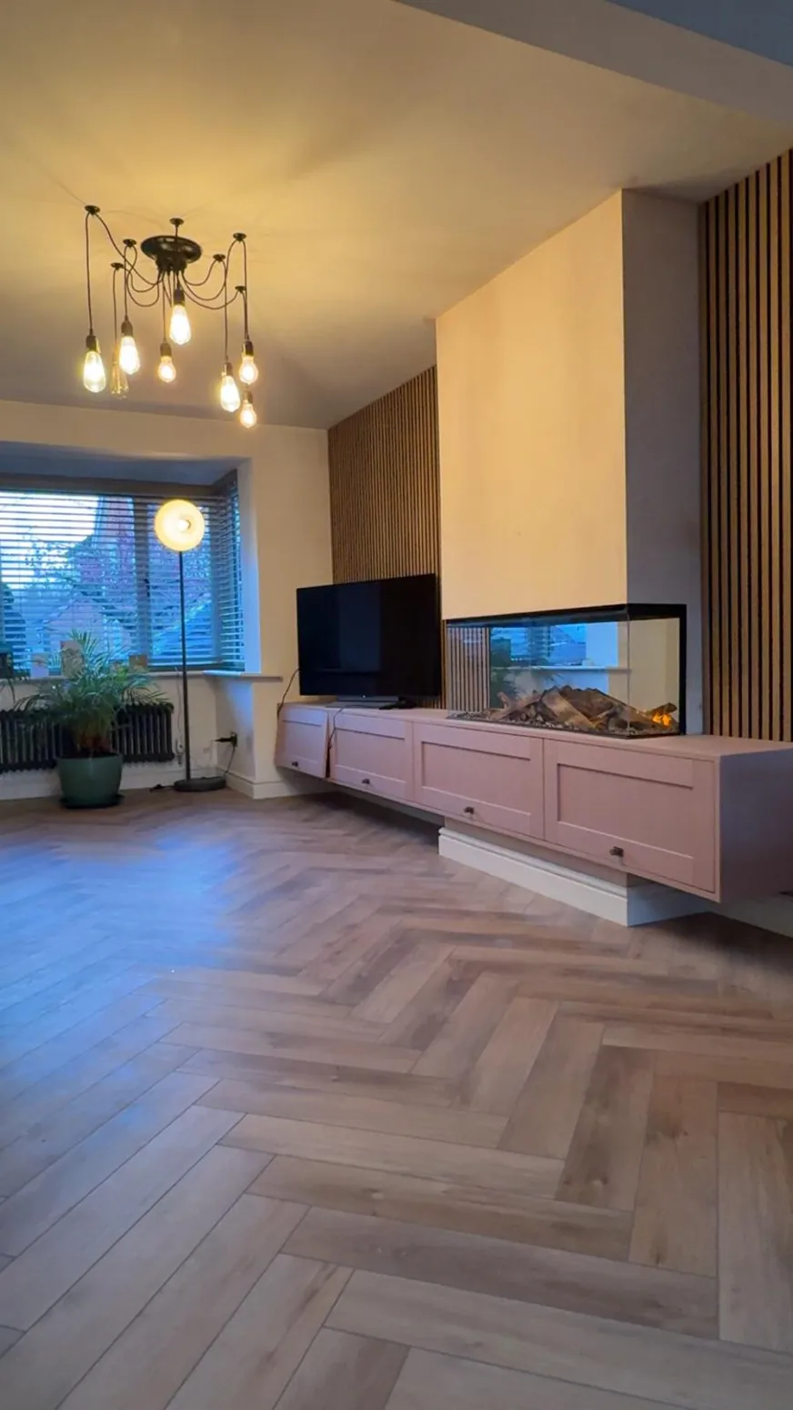 Renovated lounge with timber flooring and bespoke media unit