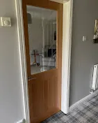 Glazed timber internal door installed in a hallway