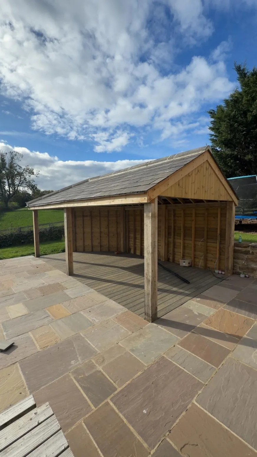 Timber garden building with pitched roof and clad walls