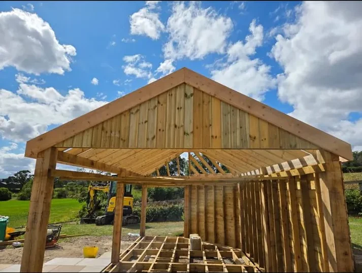 Open-sided timber garden shelter with pitched roof