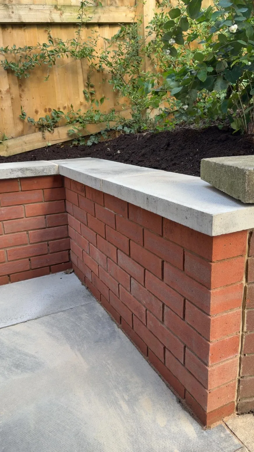 New brickwork and coping detail in landscaped outdoor space