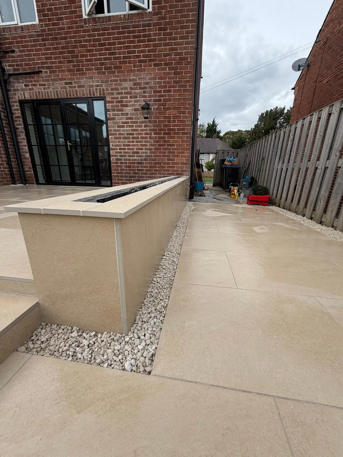 Modern porcelain paving installation and rendered wall detailing