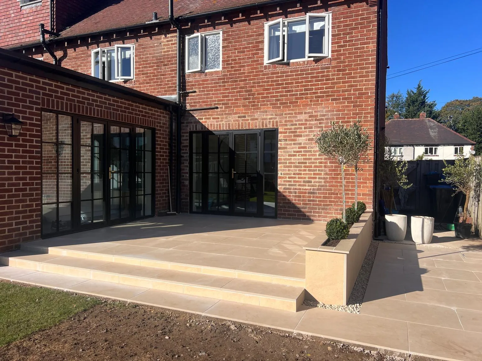 Generous porcelain patio outside bifold doors