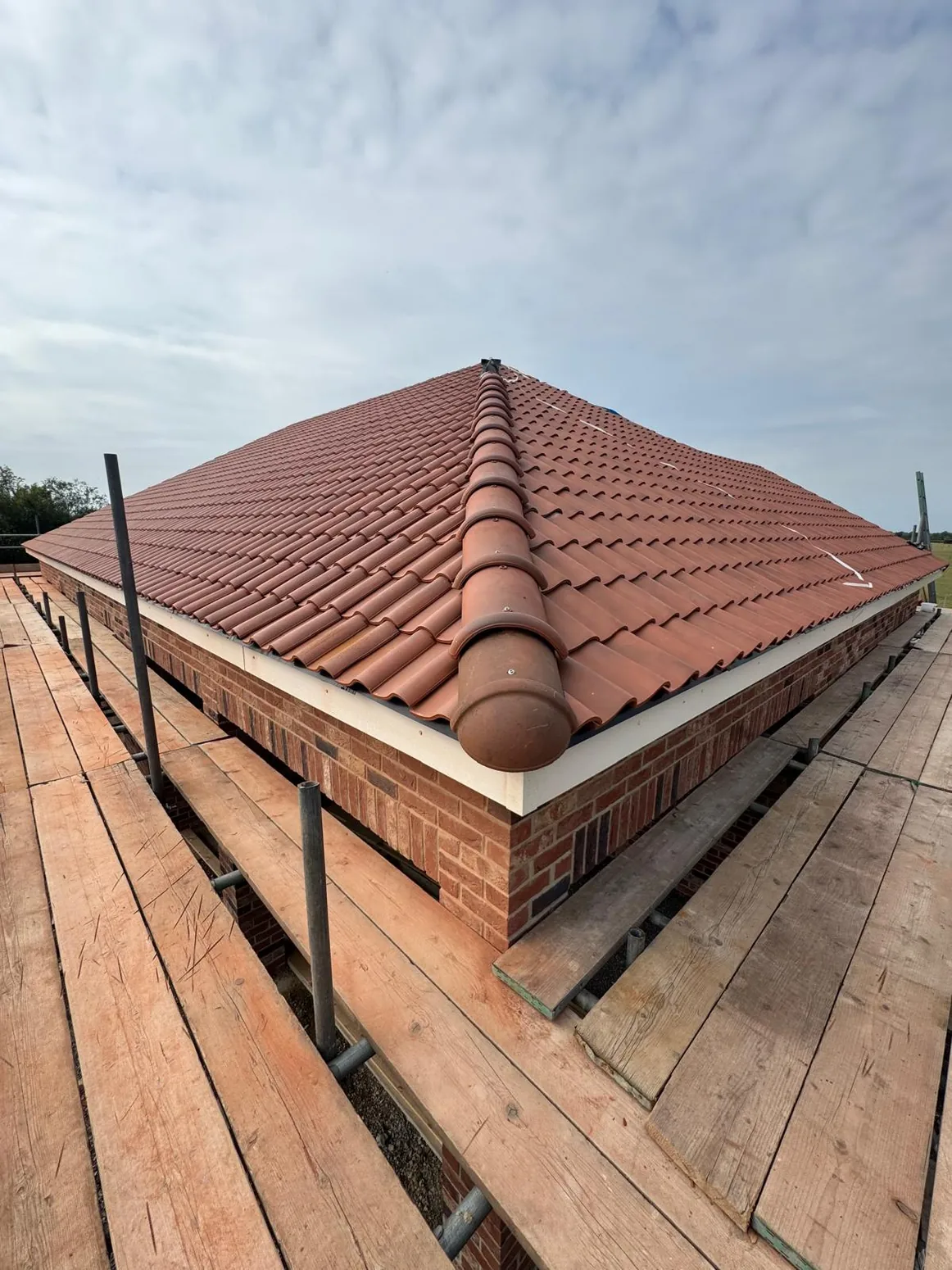 Completed pitched roof with terracotta tiles